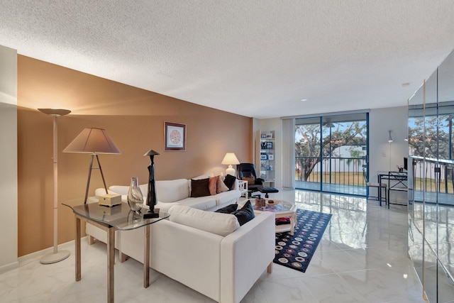 living room with floor to ceiling windows and a textured ceiling