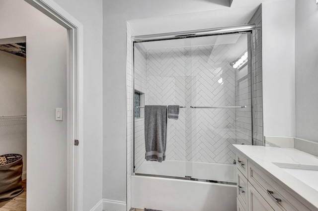 bathroom with bath / shower combo with glass door and vanity