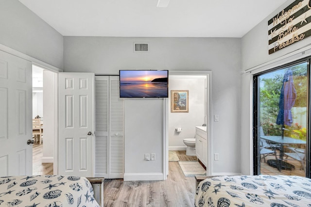 bedroom with light hardwood / wood-style flooring, connected bathroom, a closet, and access to exterior