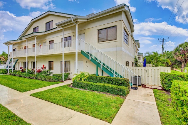 view of front of home featuring a front yard and central air condition unit