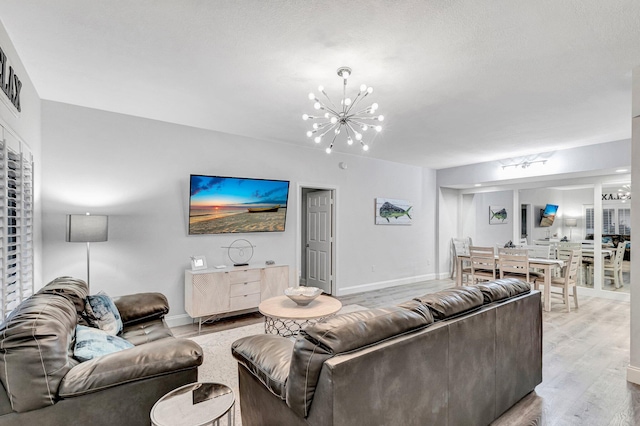 living room featuring an inviting chandelier and hardwood / wood-style flooring