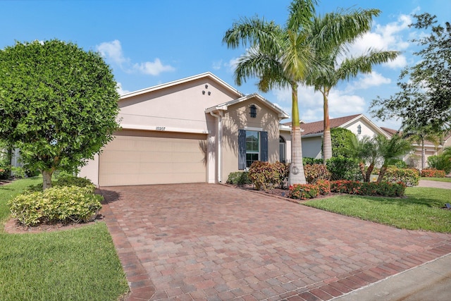 single story home featuring a garage and a front lawn