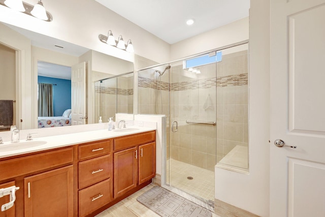 bathroom featuring tile patterned flooring, vanity, and walk in shower