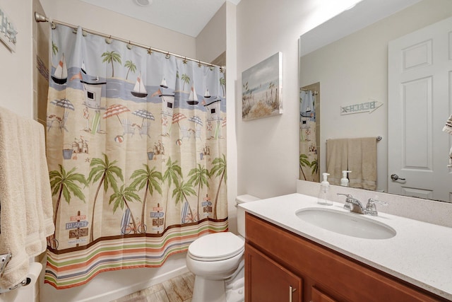 full bathroom featuring hardwood / wood-style floors, vanity, toilet, and shower / tub combo