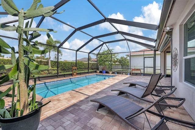 view of swimming pool featuring a lanai and a patio