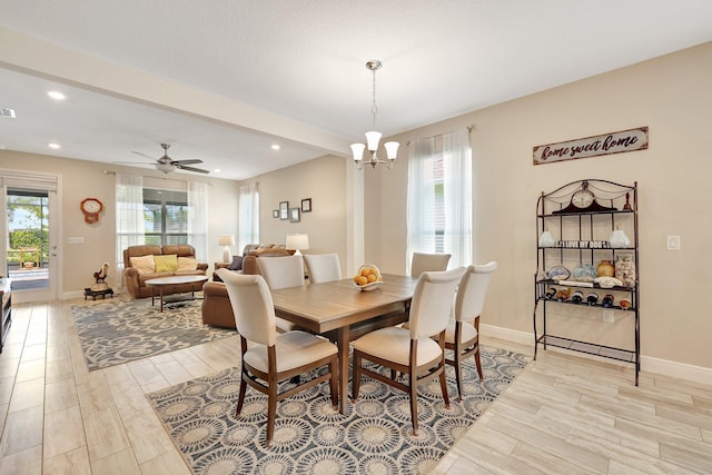 dining room featuring ceiling fan with notable chandelier