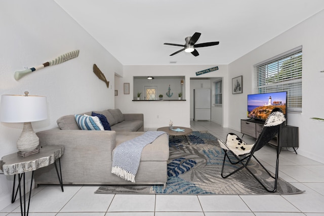 tiled living room with ceiling fan