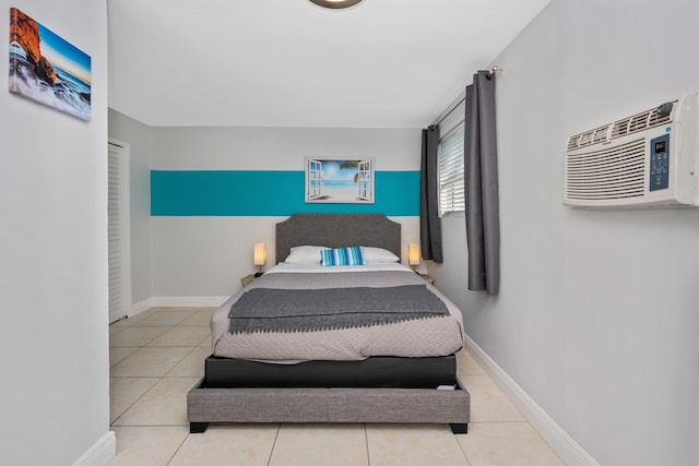 bedroom featuring tile patterned flooring and a wall unit AC