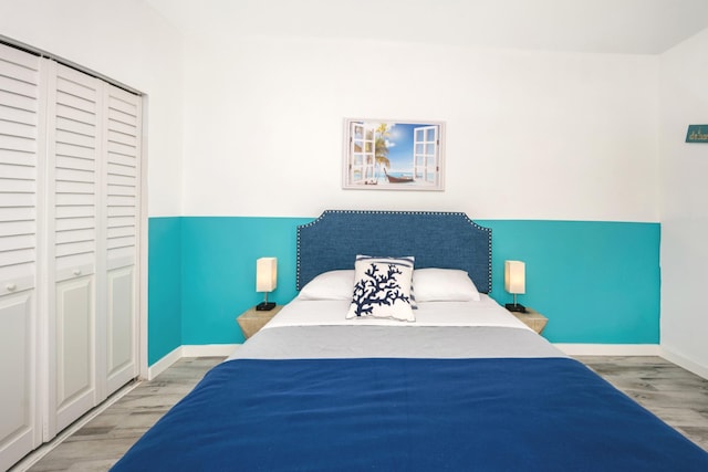 bedroom with hardwood / wood-style flooring and a closet