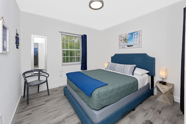 bedroom with hardwood / wood-style floors