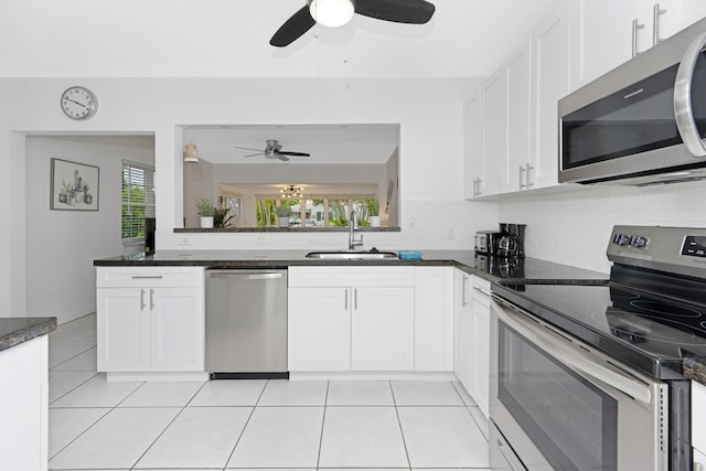 kitchen featuring white cabinets, a healthy amount of sunlight, sink, and stainless steel appliances