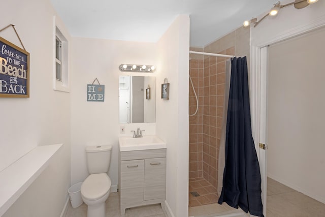 bathroom featuring toilet, a shower with curtain, vanity, and tile patterned floors