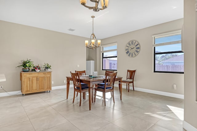 tiled dining area with a notable chandelier and plenty of natural light