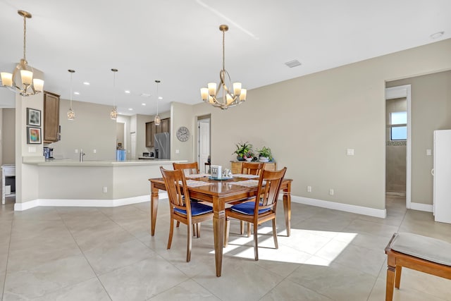 tiled dining room featuring sink and a notable chandelier