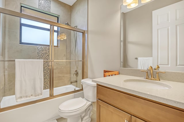 full bathroom with toilet, vanity, and bath / shower combo with glass door