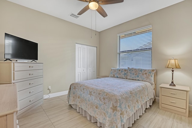 bedroom featuring light tile patterned flooring, a closet, and ceiling fan