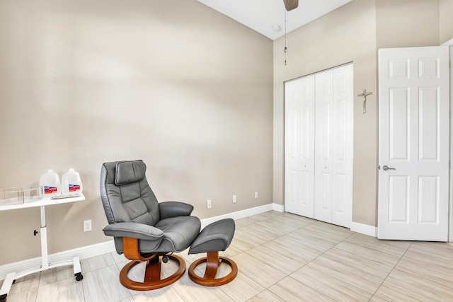 living area with high vaulted ceiling, light tile patterned flooring, and ceiling fan