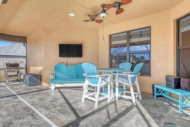 view of patio featuring ceiling fan and a grill