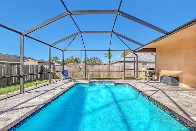 view of pool with a patio and glass enclosure