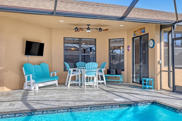 view of pool with ceiling fan and a patio