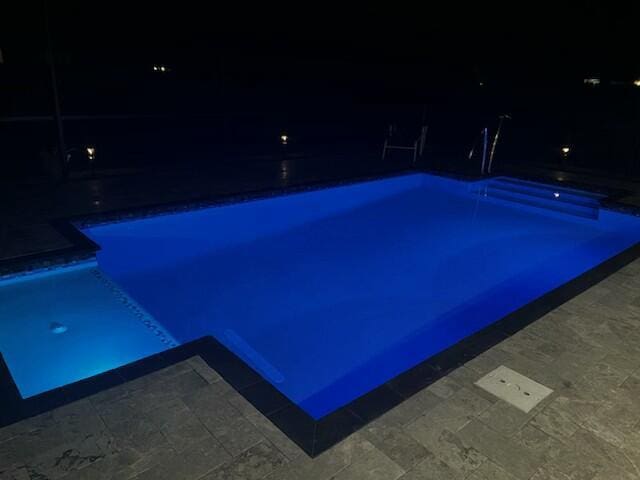 view of pool at night