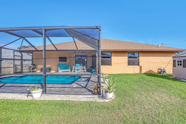 view of swimming pool with a lawn, a patio area, area for grilling, and glass enclosure