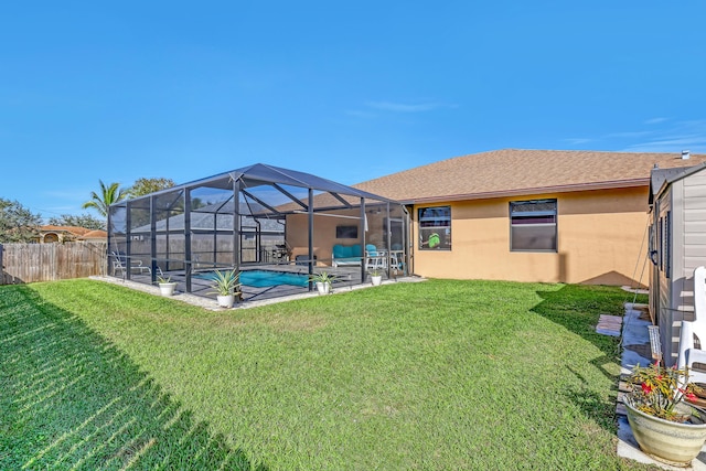 view of yard featuring a fenced in pool, a patio area, and glass enclosure