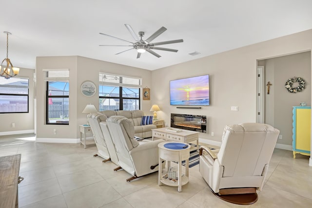 living room featuring ceiling fan and light tile patterned flooring