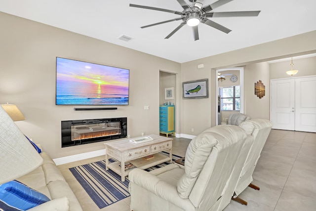 tiled living room with ceiling fan