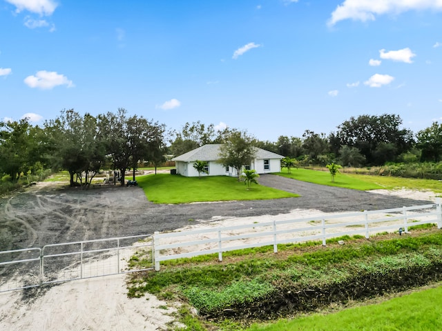 view of front facade featuring a rural view and a front yard