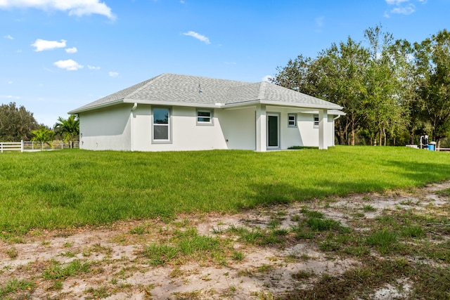 back of house featuring a yard