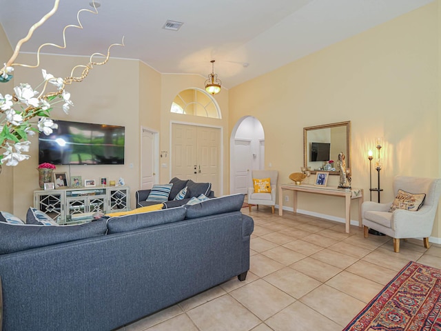 tiled living room featuring a high ceiling