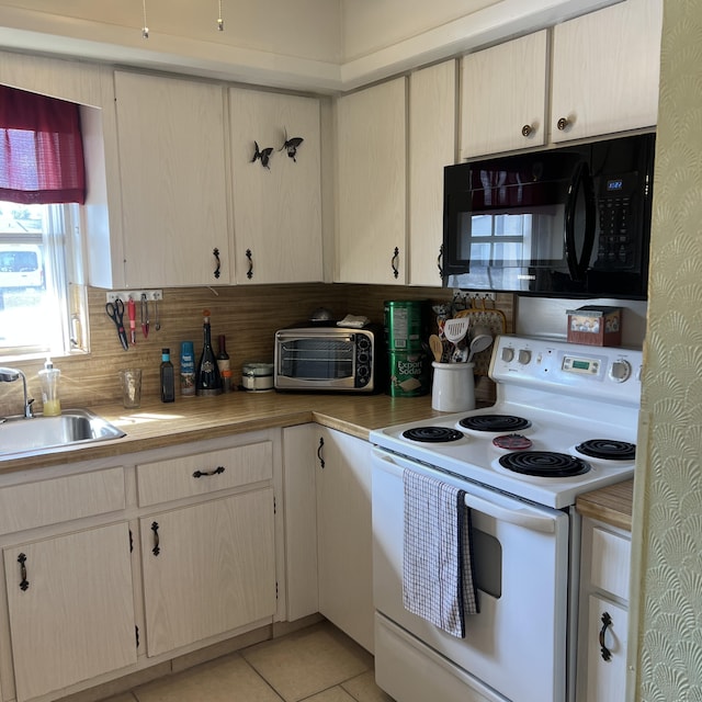 kitchen with a toaster, white electric stove, light tile patterned floors, a sink, and black microwave