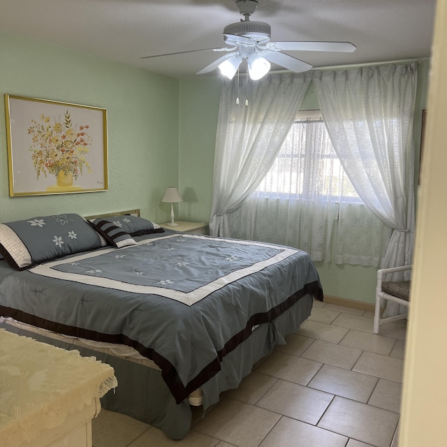 bedroom with tile patterned flooring and a ceiling fan