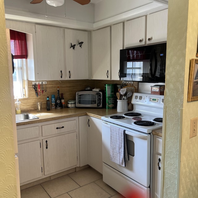 kitchen with electric stove, a toaster, light tile patterned floors, ceiling fan, and black microwave