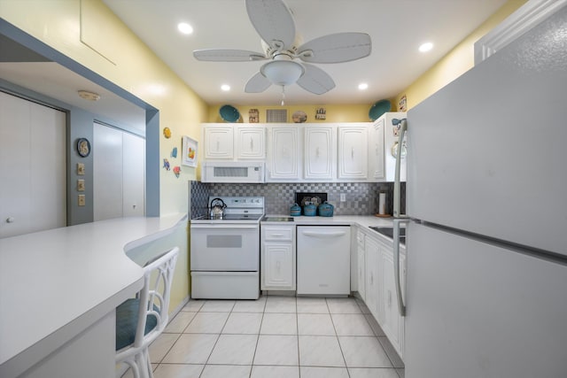 kitchen featuring white appliances, backsplash, ceiling fan, light tile patterned floors, and white cabinetry