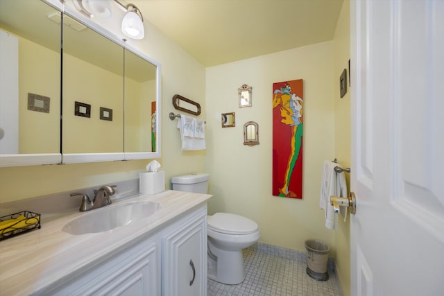 bathroom featuring tile patterned floors, vanity, and toilet