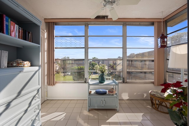 sunroom featuring a wealth of natural light and ceiling fan