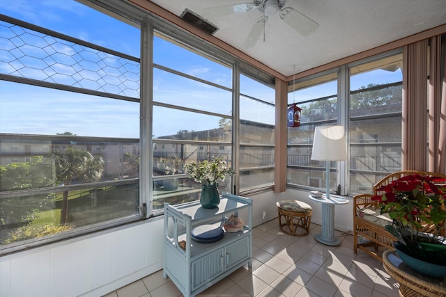 sunroom / solarium featuring plenty of natural light and ceiling fan