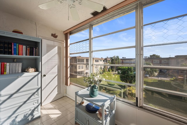 sunroom with ceiling fan and a healthy amount of sunlight