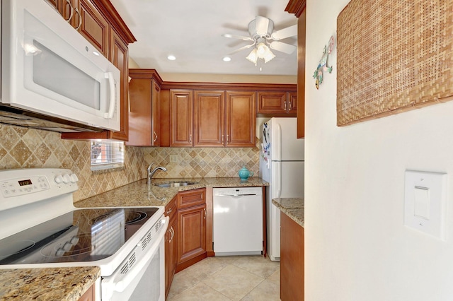 kitchen featuring ceiling fan, sink, light stone counters, white appliances, and light tile patterned floors