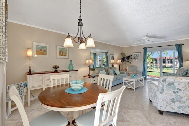 tiled dining room featuring ceiling fan with notable chandelier, ornamental molding, and a textured ceiling