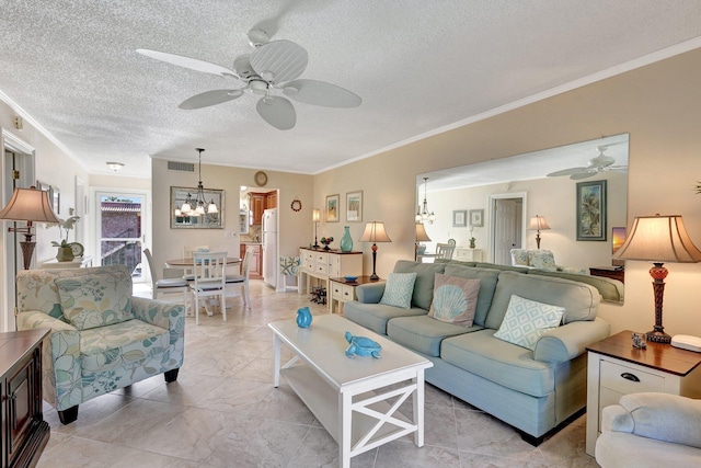 living room with a textured ceiling, ceiling fan with notable chandelier, and crown molding