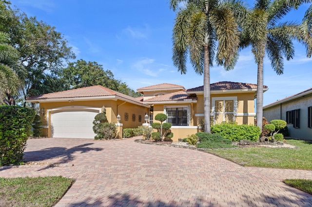 mediterranean / spanish house with a garage