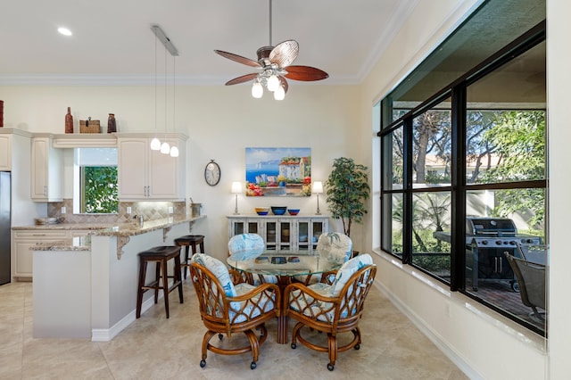 dining room featuring ceiling fan, crown molding, and light tile patterned flooring