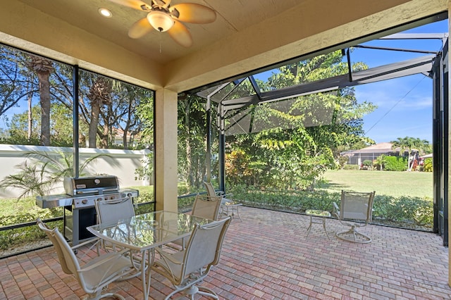 unfurnished sunroom with ceiling fan