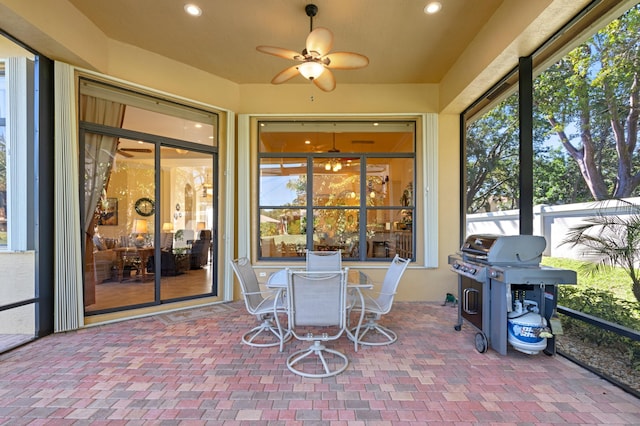 sunroom featuring ceiling fan