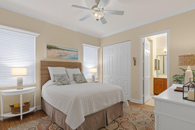 bedroom featuring ceiling fan, connected bathroom, crown molding, and light wood-type flooring