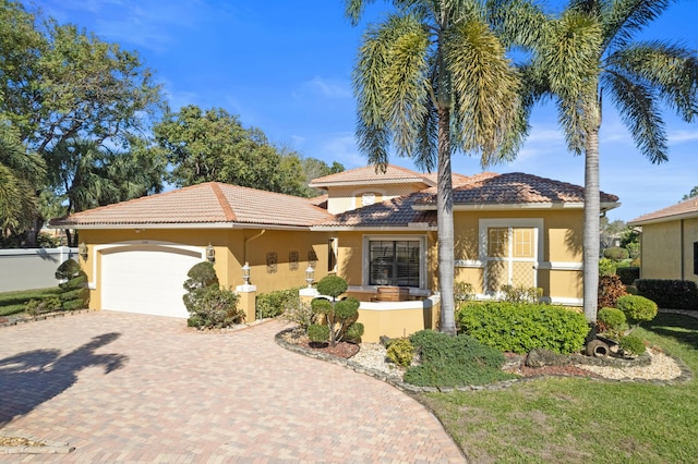 mediterranean / spanish-style home with a garage