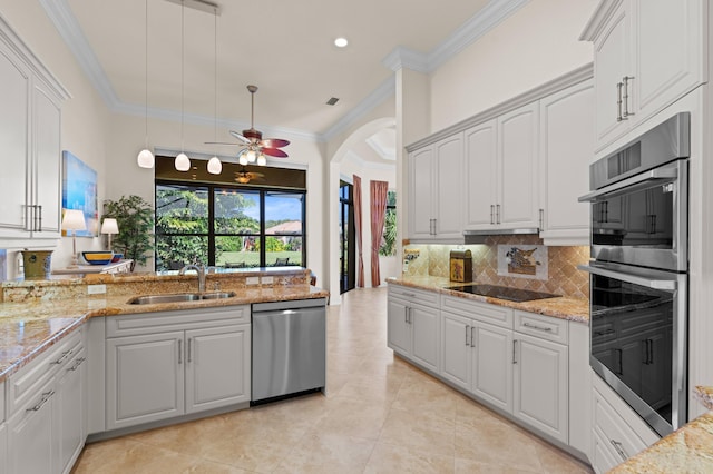 kitchen with white cabinets, appliances with stainless steel finishes, sink, and pendant lighting